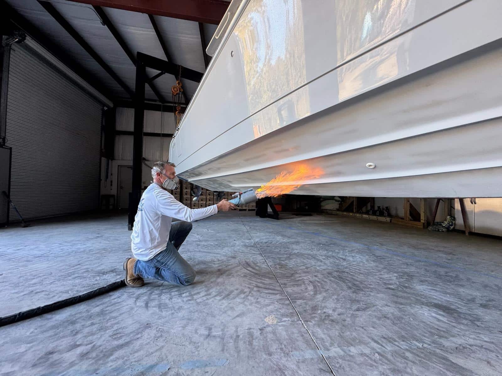 Boat bottom protection coating application in progress